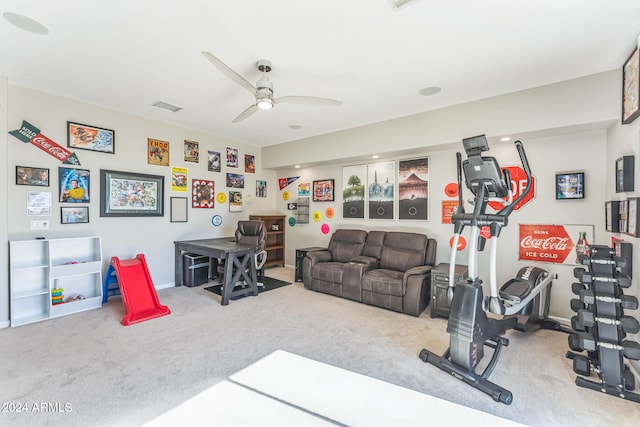 exercise area featuring ceiling fan and carpet