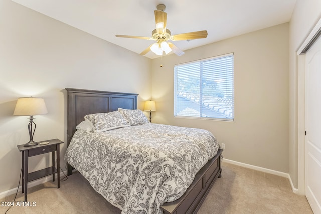 carpeted bedroom featuring ceiling fan and a closet