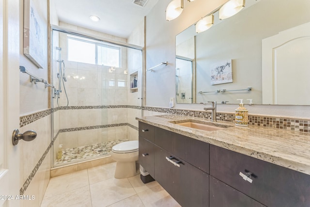 bathroom featuring walk in shower, tile patterned flooring, vanity, and toilet