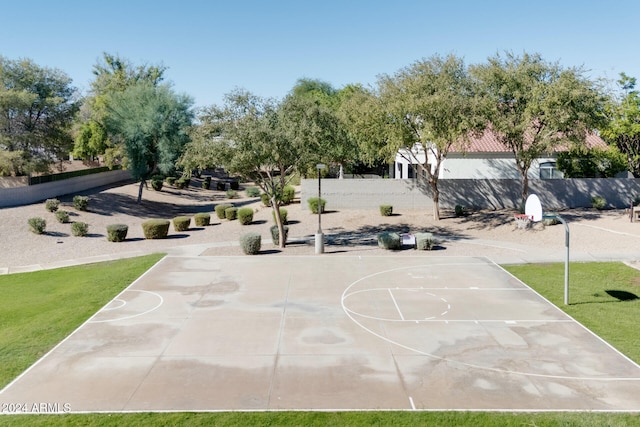 exterior space with basketball court and a yard