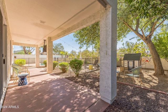 view of patio / terrace with a storage shed