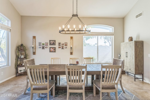 dining room featuring a notable chandelier and lofted ceiling