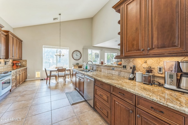 kitchen with light tile patterned flooring, sink, a chandelier, pendant lighting, and dishwasher