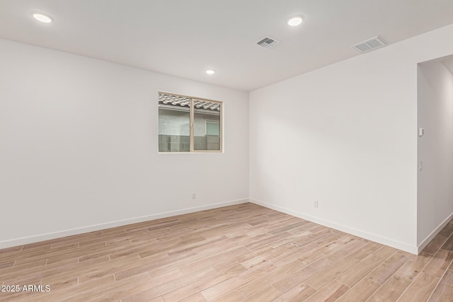 spare room featuring light wood-type flooring