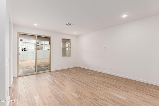 spare room with light hardwood / wood-style flooring