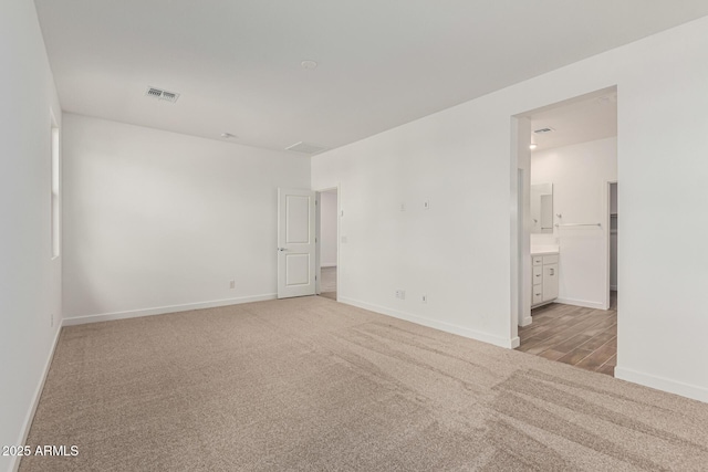 spare room with light colored carpet