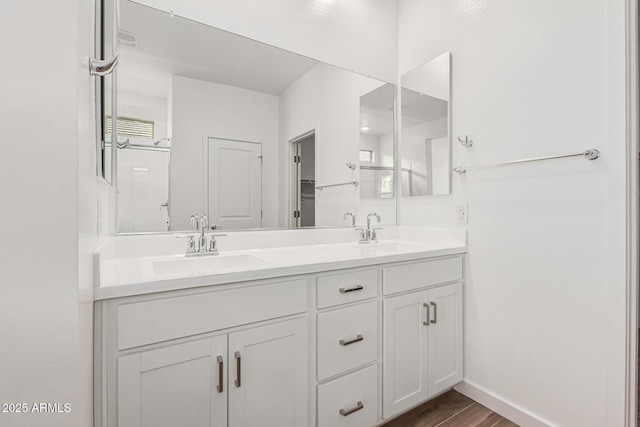 bathroom featuring hardwood / wood-style flooring and vanity