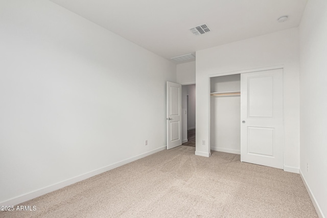 unfurnished bedroom featuring carpet floors and a closet