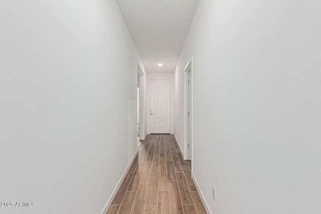 corridor featuring wood-type flooring