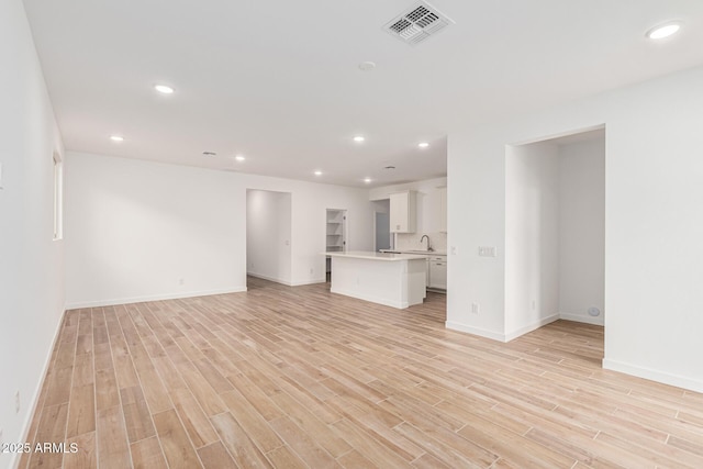 unfurnished living room featuring light wood-type flooring