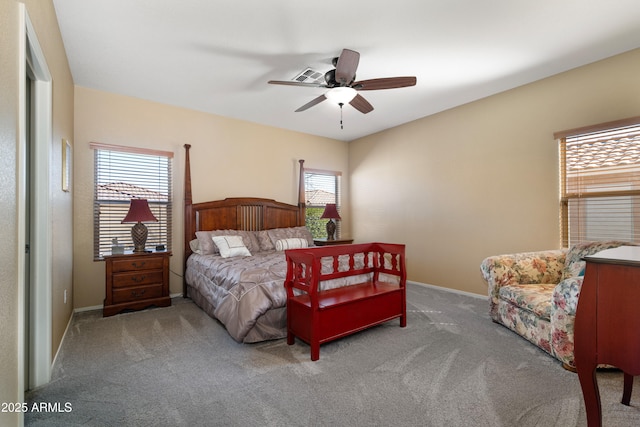 bedroom with a ceiling fan, carpet flooring, and baseboards