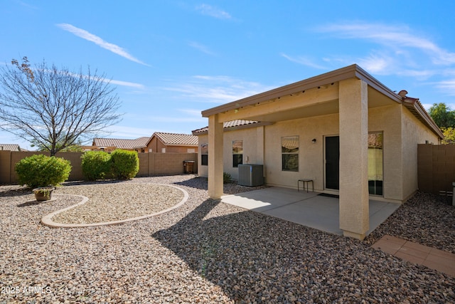 back of house with a patio, central AC unit, a fenced backyard, and stucco siding