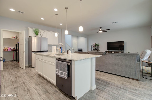kitchen featuring a sink, visible vents, white cabinets, and stainless steel appliances
