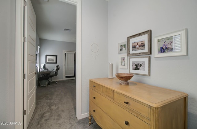 hallway with visible vents and dark colored carpet