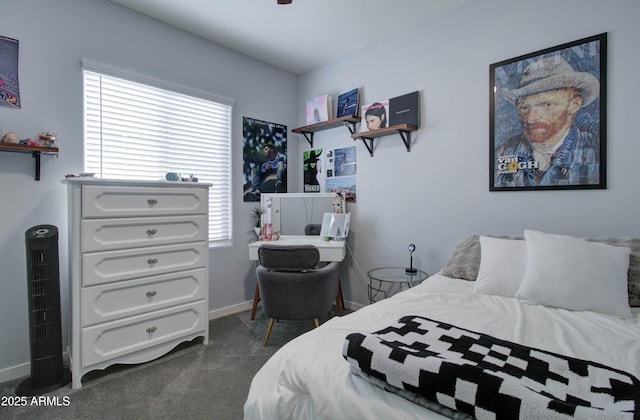 bedroom featuring dark carpet, baseboards, and multiple windows