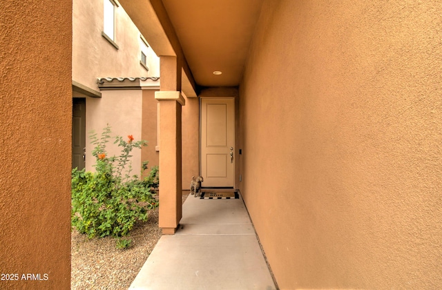 entrance to property with stucco siding