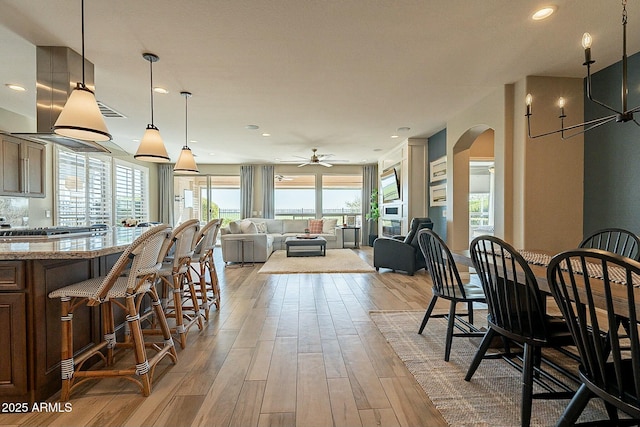 dining area featuring ceiling fan and light wood-type flooring