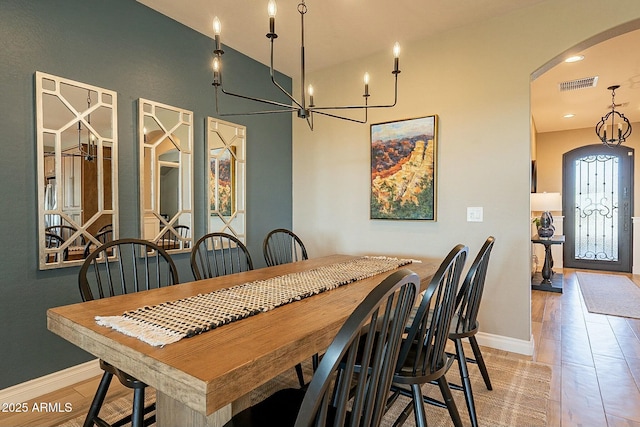 dining room with an inviting chandelier and light hardwood / wood-style floors