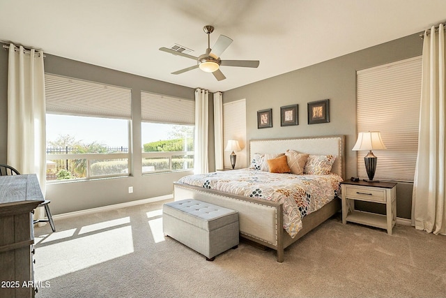 bedroom with ceiling fan and light carpet