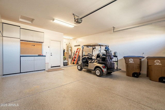 garage featuring a garage door opener and electric water heater