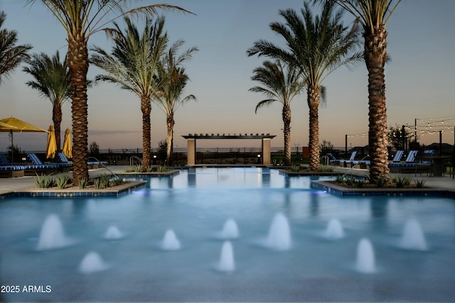 view of pool at dusk