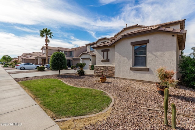 mediterranean / spanish-style house with stucco siding, an attached garage, driveway, and a tile roof