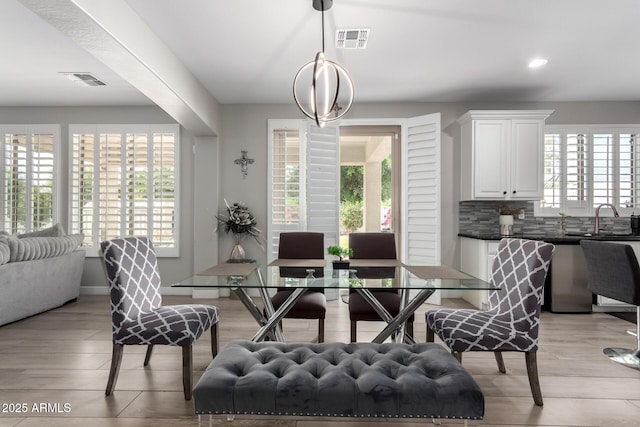 dining space featuring recessed lighting, light wood-style floors, and visible vents