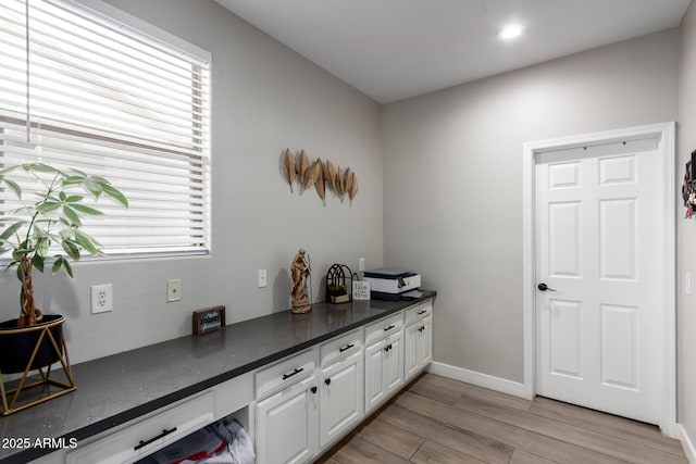 home office with recessed lighting, light wood-style floors, plenty of natural light, and baseboards