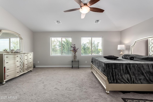bedroom with lofted ceiling, multiple windows, and visible vents