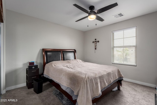 carpeted bedroom featuring baseboards, a ceiling fan, and visible vents