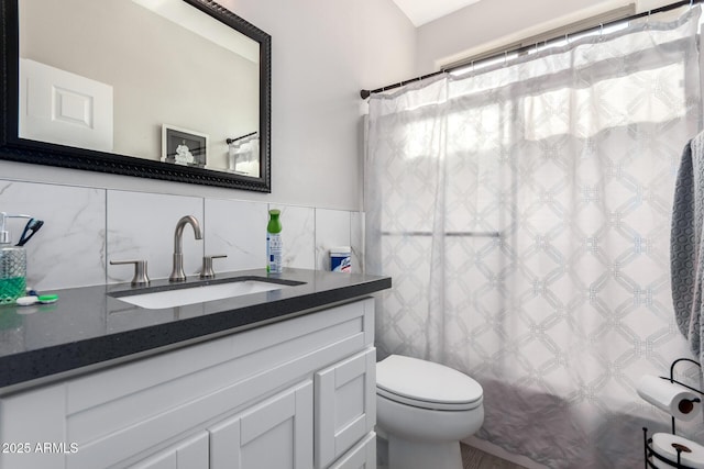 full bath with decorative backsplash, vanity, curtained shower, tile walls, and toilet