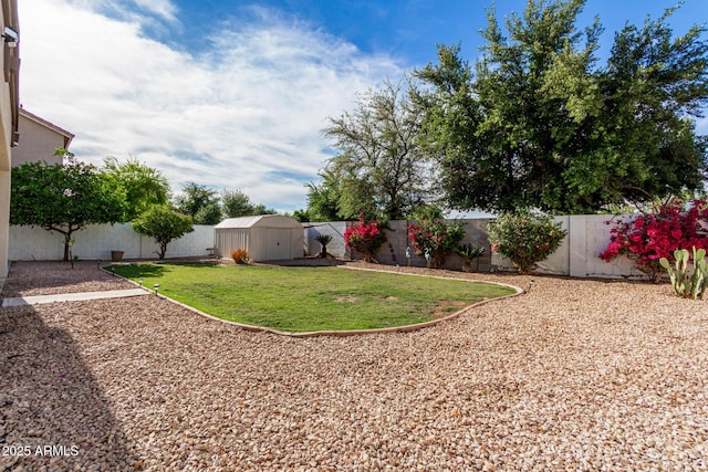 view of yard featuring a fenced backyard, an outbuilding, and a storage shed
