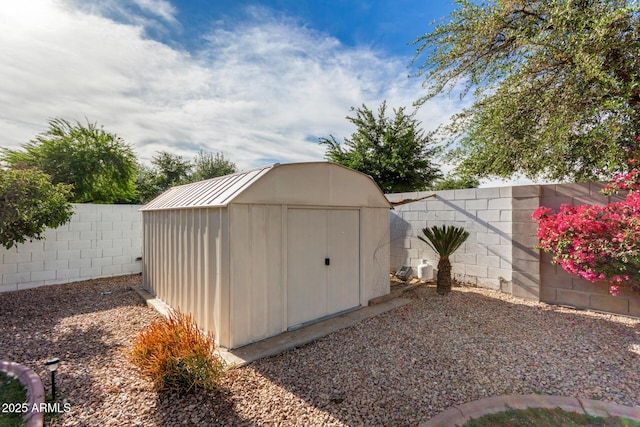 view of shed with a fenced backyard