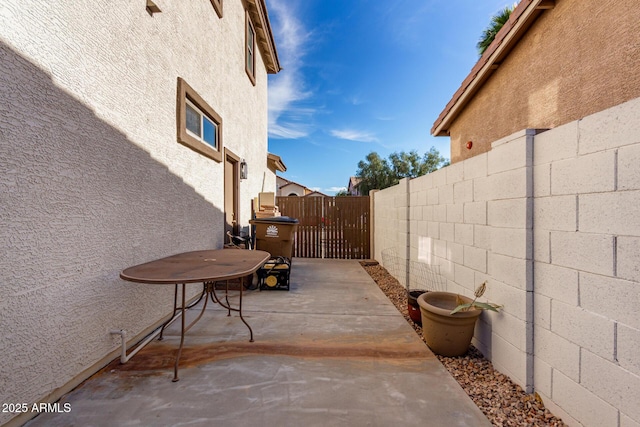 view of patio featuring fence