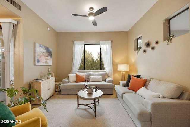 carpeted living room featuring ceiling fan