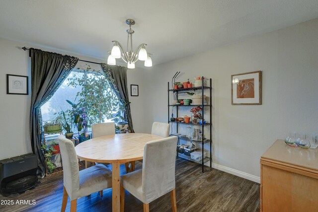 dining room featuring an inviting chandelier and dark wood-type flooring