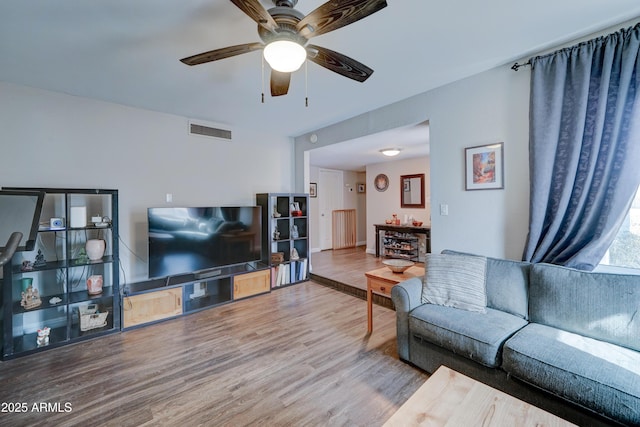 living room with hardwood / wood-style floors and ceiling fan