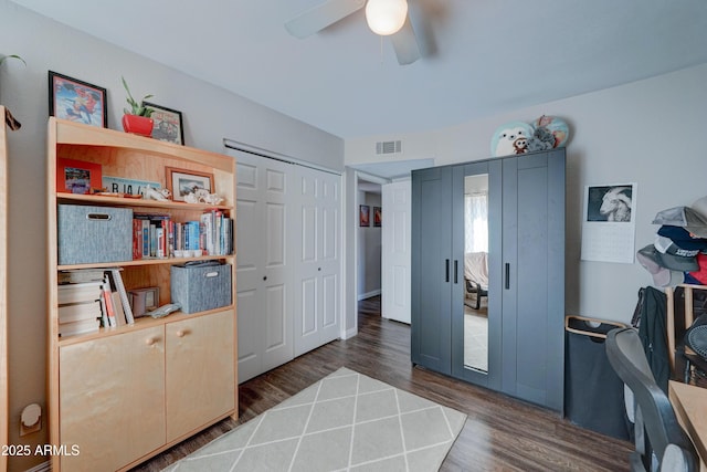 interior space featuring ceiling fan and dark hardwood / wood-style flooring