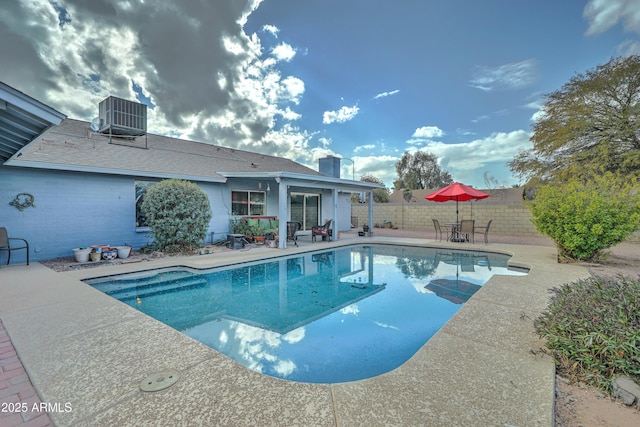 view of pool with a patio and central AC unit