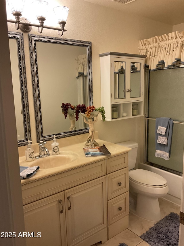 full bathroom featuring tile patterned flooring, vanity, bath / shower combo with glass door, and toilet