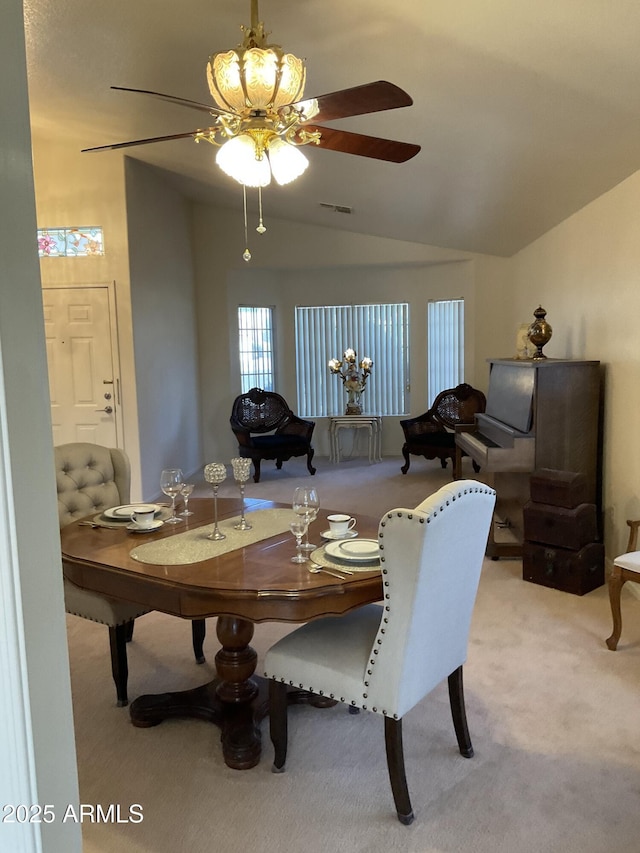 carpeted dining area with lofted ceiling and ceiling fan