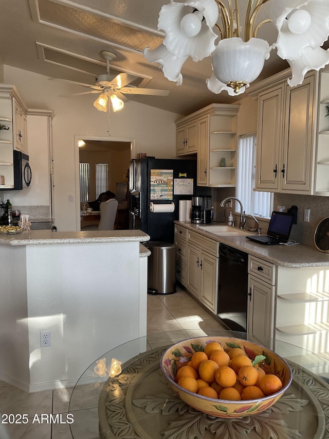 kitchen featuring sink, light tile patterned floors, cream cabinetry, and black appliances