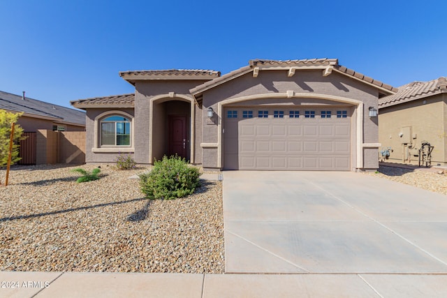 mediterranean / spanish-style home featuring a garage