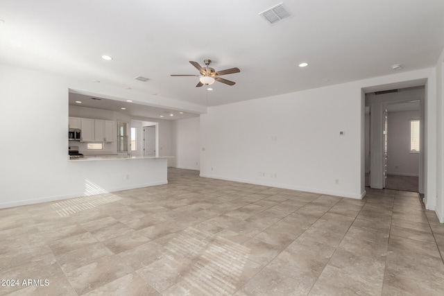 unfurnished living room with ceiling fan