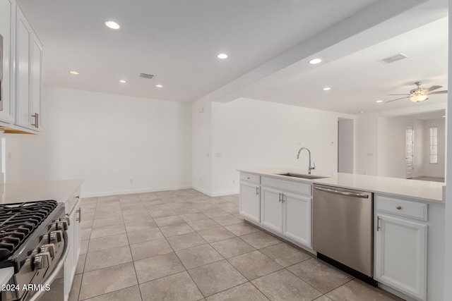 kitchen featuring ceiling fan, stainless steel appliances, sink, and white cabinets