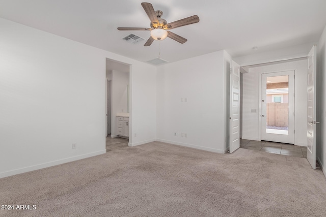 empty room featuring ceiling fan and light carpet