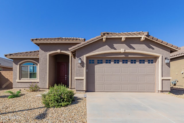 mediterranean / spanish-style home featuring a garage