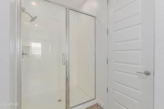 bathroom with a shower with shower door