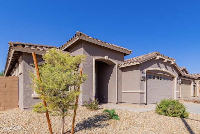 mediterranean / spanish-style home featuring a garage