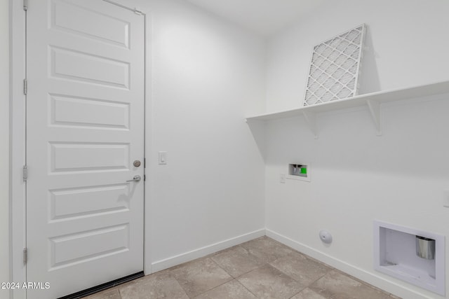 laundry area with hookup for a gas dryer, hookup for a washing machine, and light tile patterned floors